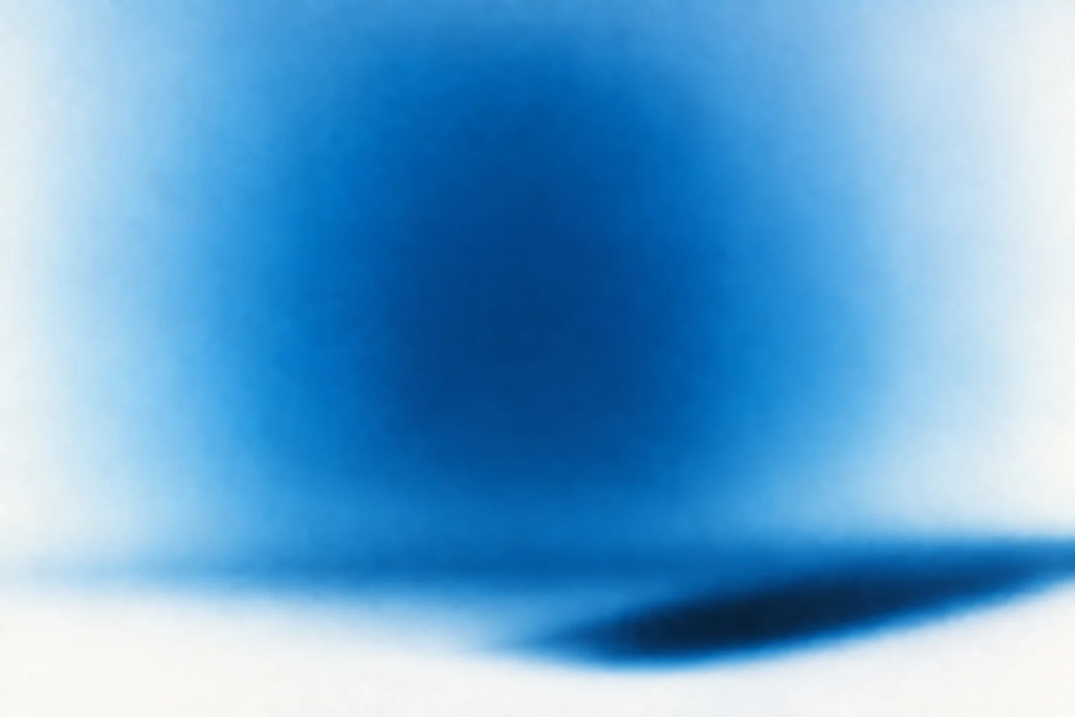 Blue and white studio backdrop with a long diagonal shadow