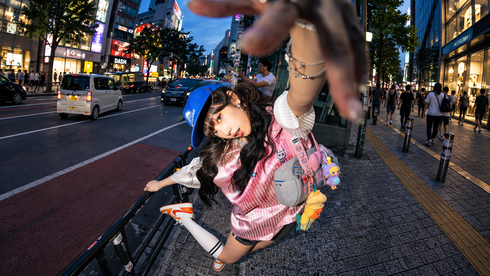Woman reaching toward the camera on a city street at dusk