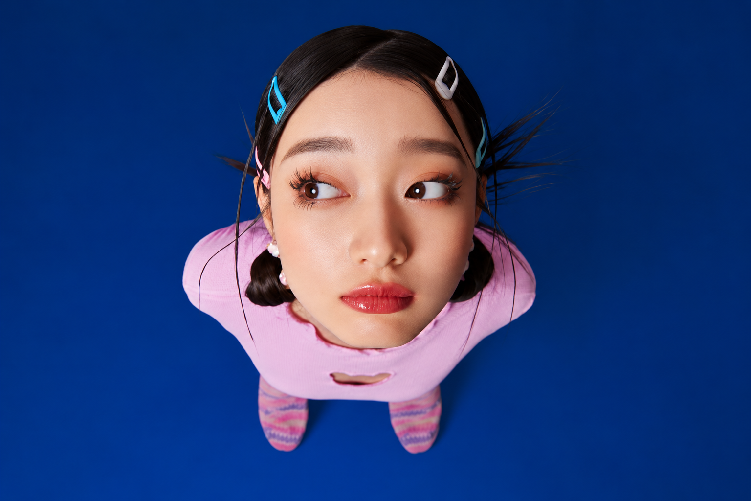 Overhead portrait against a deep blue background