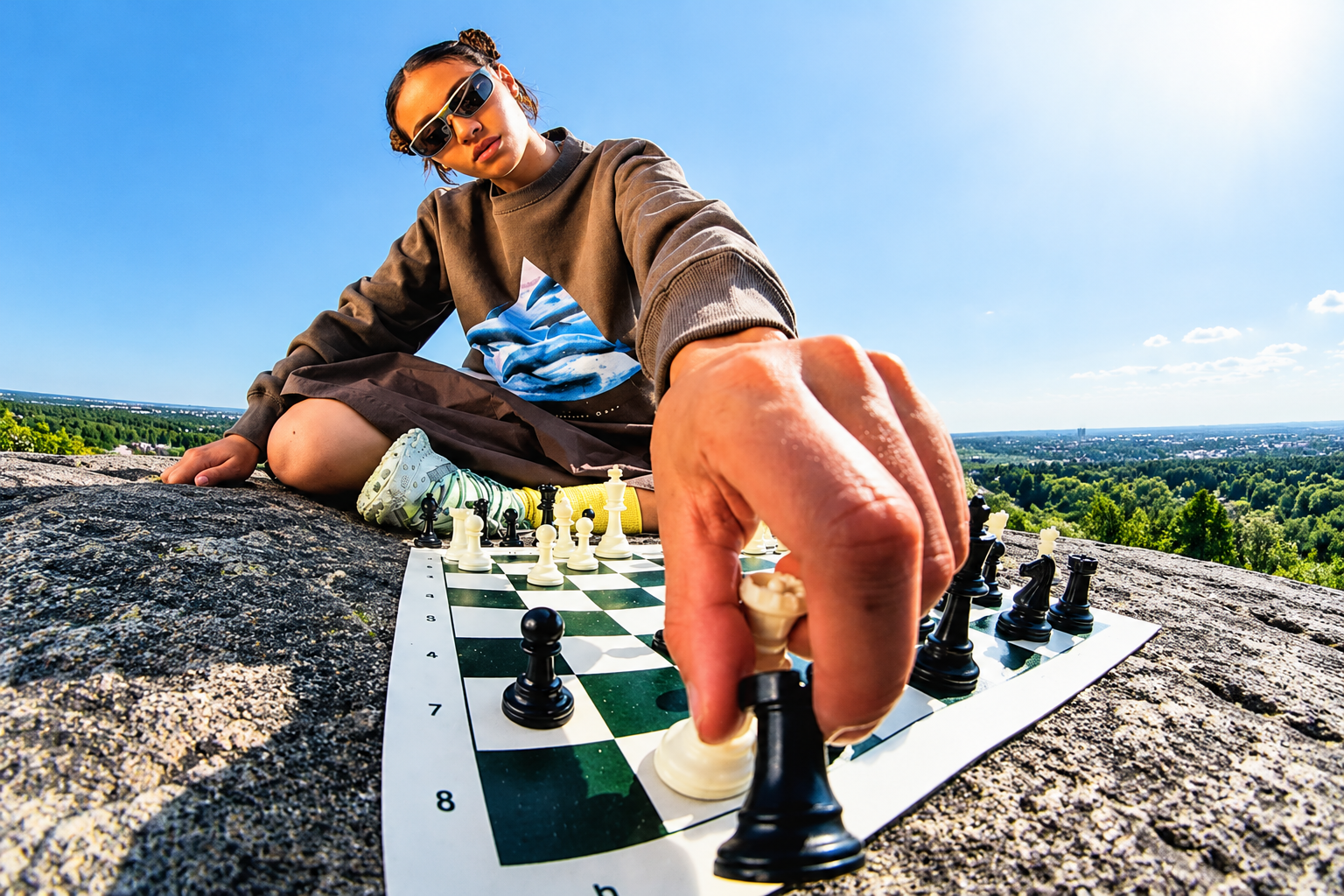 Chess player outdoors under a blue sky