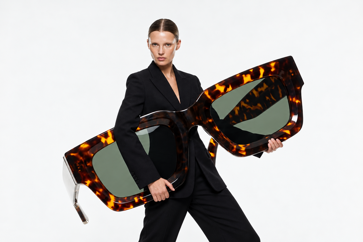 Woman holding oversized sunglasses